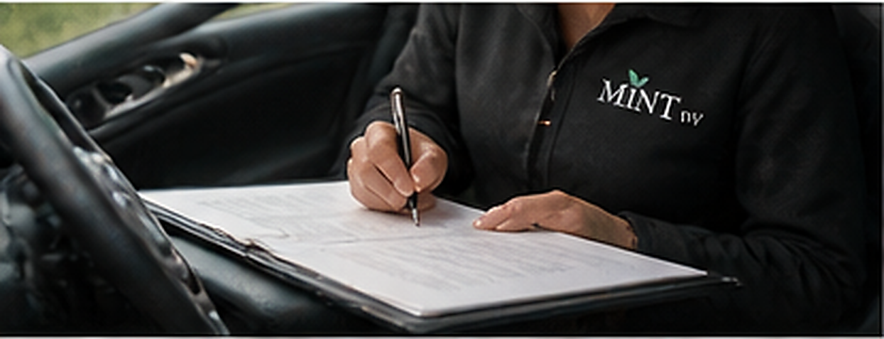 Mobile notary preparing documents beside a vehicle